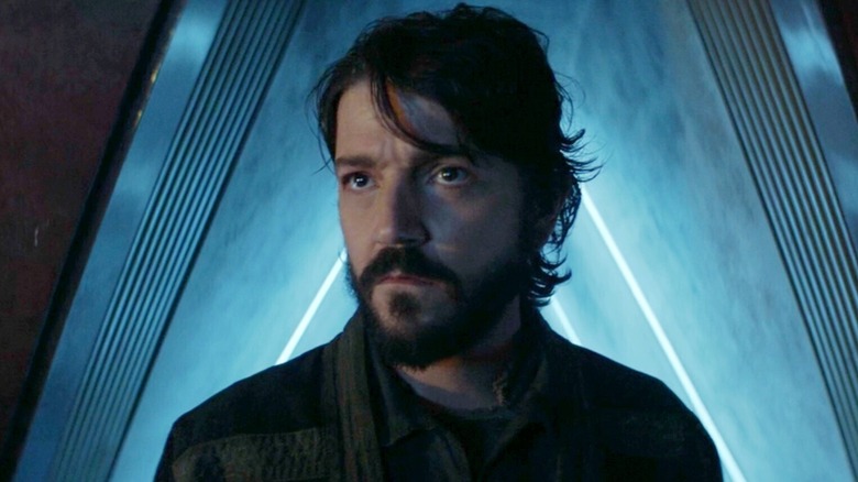 Diego Luna as Cassian Andor standing by doorway with brooding look