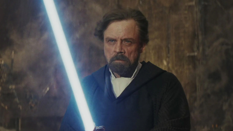 Luke Skywalker wields a lightsaber