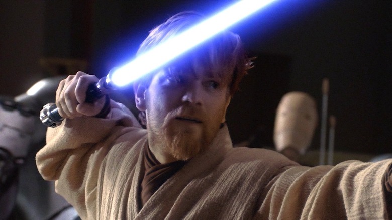 Obi-Wan holding lightsaber near head