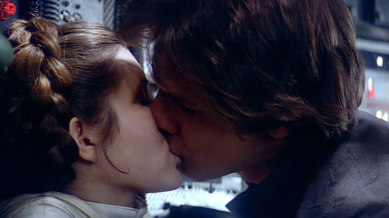 Han Solo and Princess Leia Organa kiss onboard the Millenium Falcon.