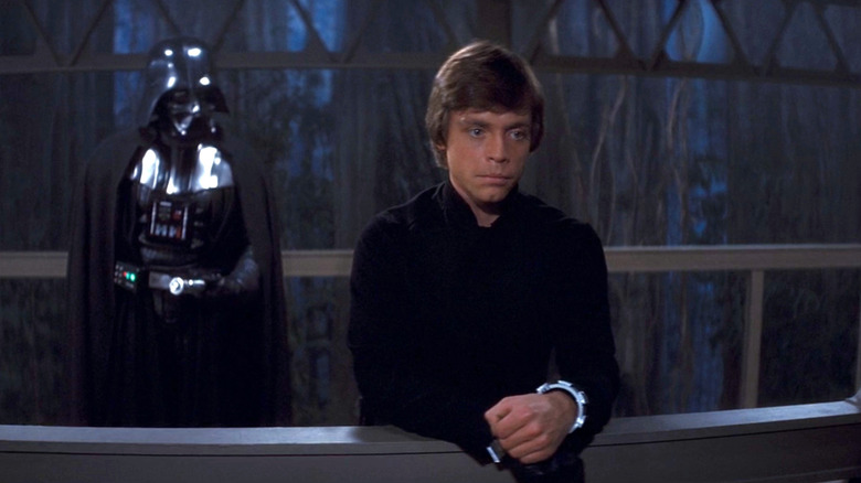 Darth Vader standing behind Luke Skywalker