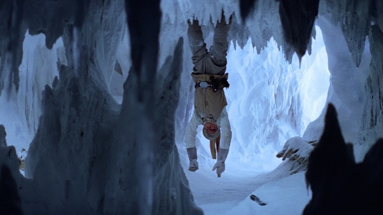 Luke hanging from the ceiling in an icy cave