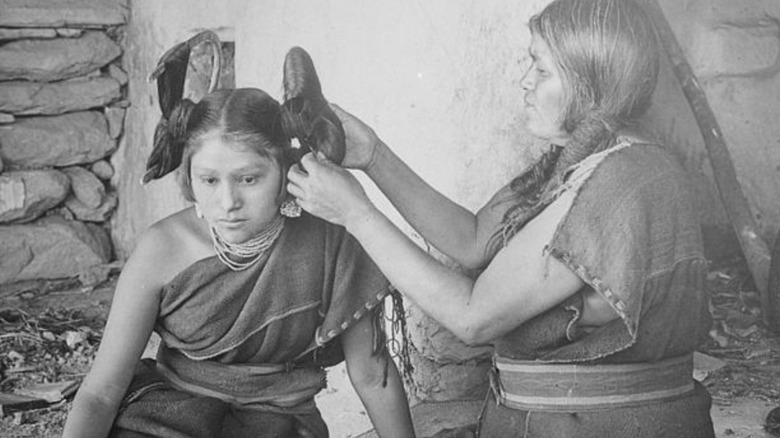 A Hopi woman having her hair done