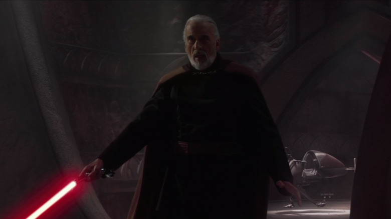 Count Dooku holding his lightsaber