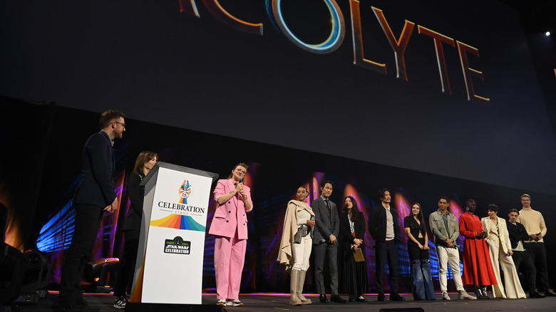 The Acolyte cast standing on stage together