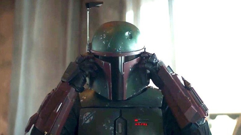 Boba putting on his helmet