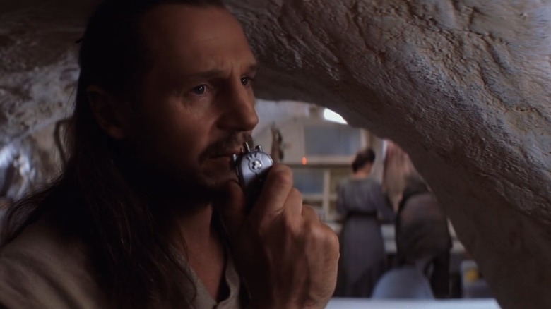 Liam Neeson as Qui-Gon using communicator