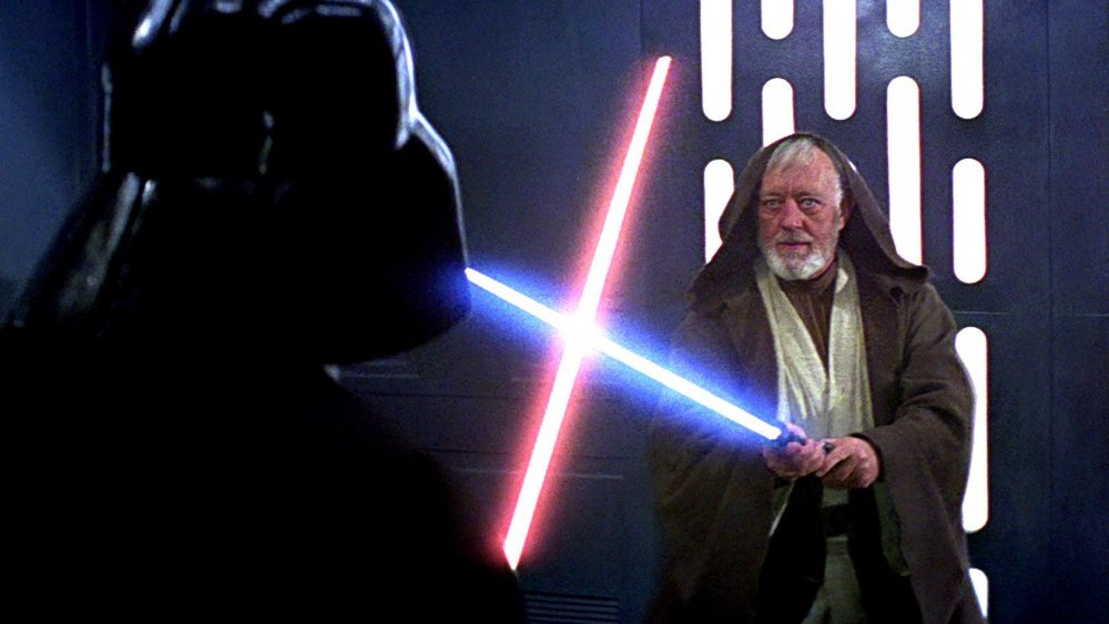 Sir Alec Guinness as Obi-Wan Kenobi, facing Darth Vader in Star Wars: A New Hope