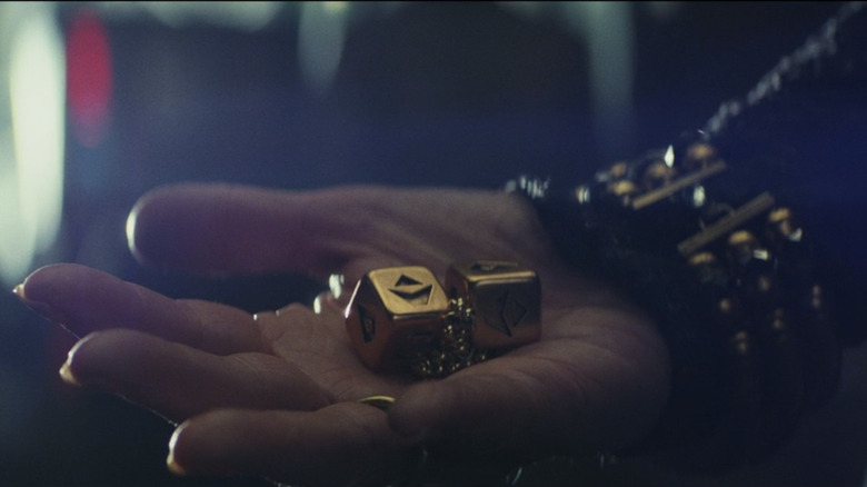 Hand holding gold dice