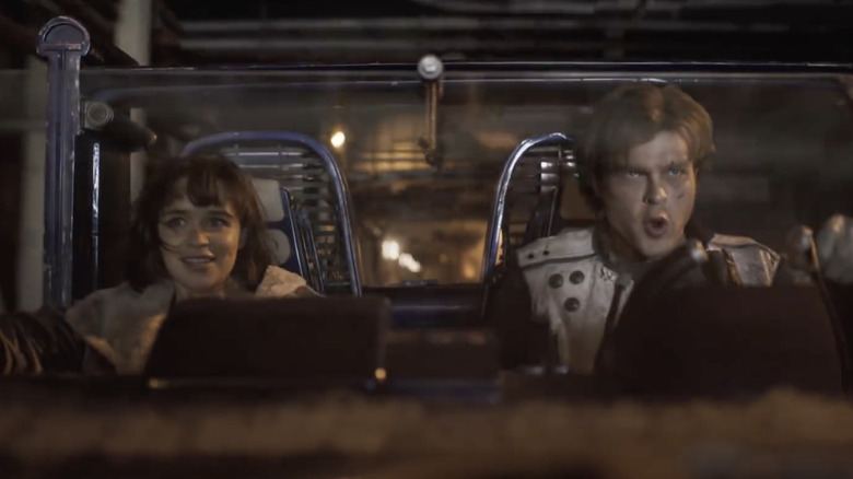 Han Solo and Qi'ra in a speeder on Corellia