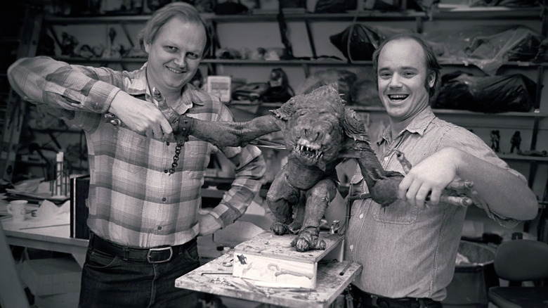 Dennis Muren and Phil Tippett holding rancor puppet