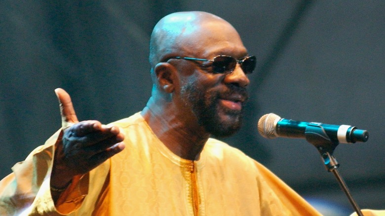 Isaac Hayes stands at microphone