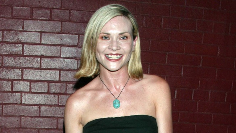 Amy Locane in front of brick wall