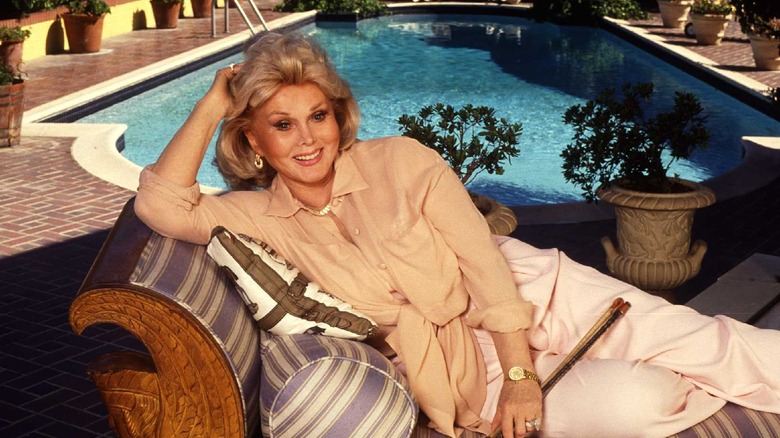 Zsa Zsa Gabor reclines on a couch