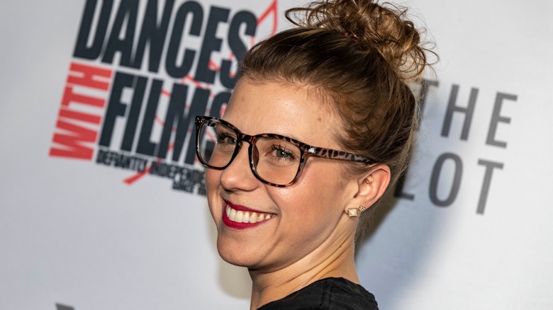 Jodie Sweetin smiling wearing glasses