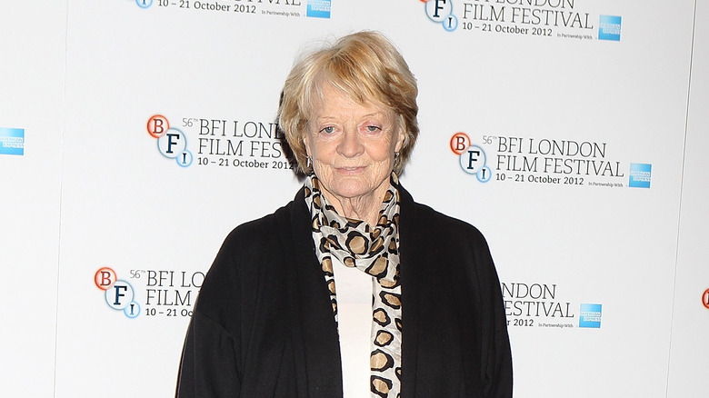 Maggie Smith smiling in leopard scarf