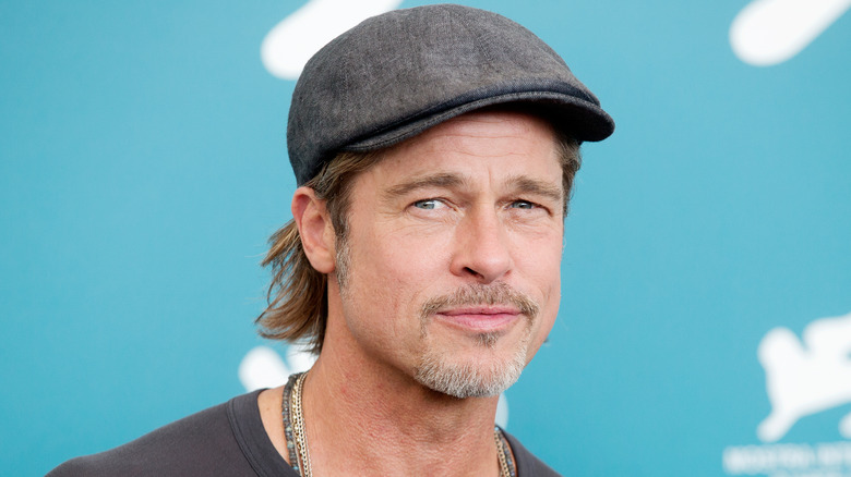 Brad Pitt in a hat, posing