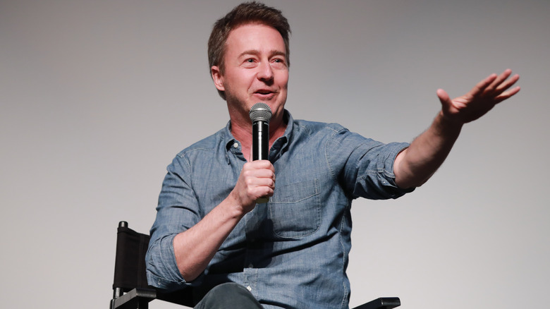 Edward Norton speaking into a microphone