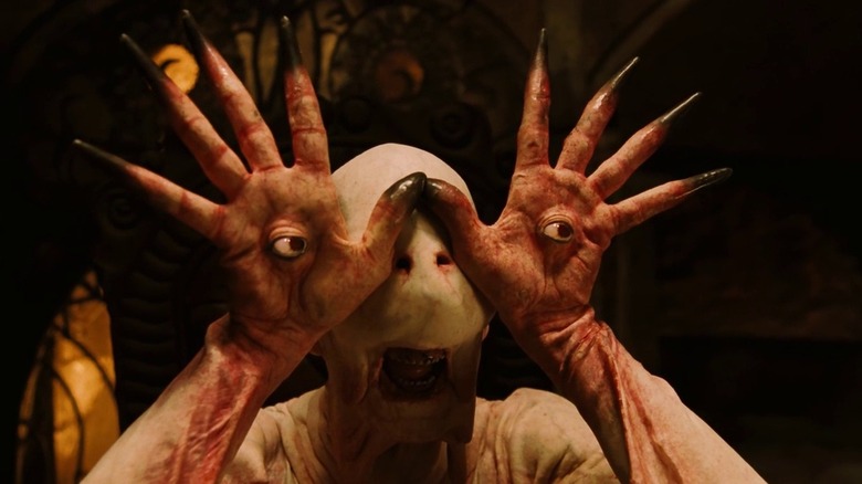 The Pale man with his eye hands raised