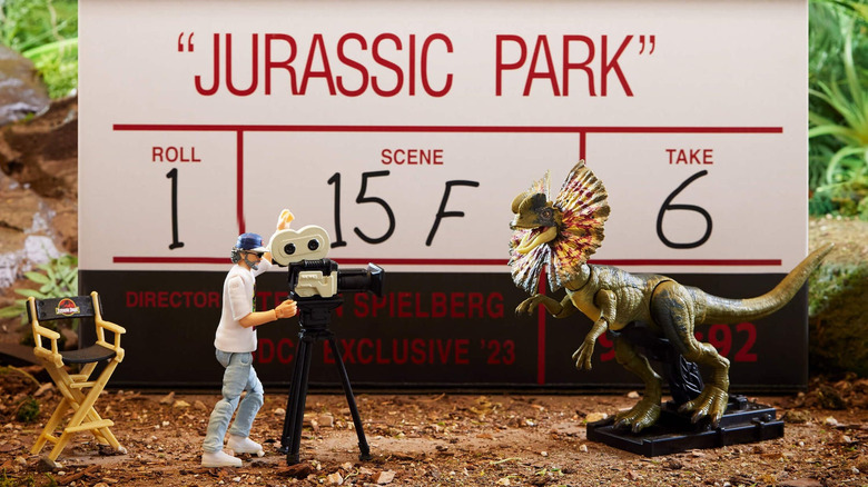 Spielberg figure stands in front of box