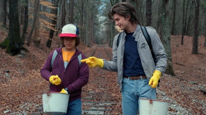 Dustin and Steve hanging out in woods