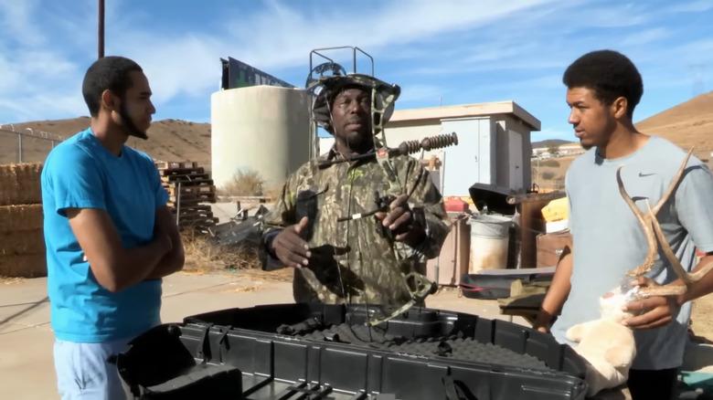 Justin Bryant looking at a crossbow