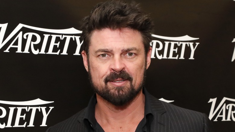 Karl Urban smirking