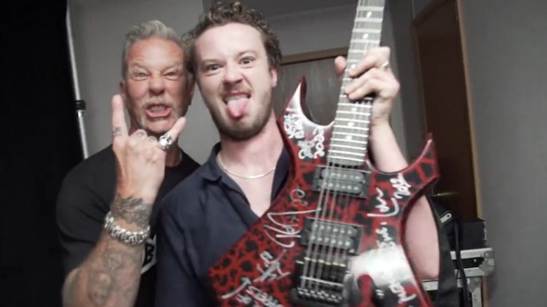 Hetfield and Quinn with guitar