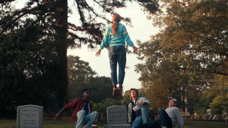 Max Mayfield levitating on a graveyard