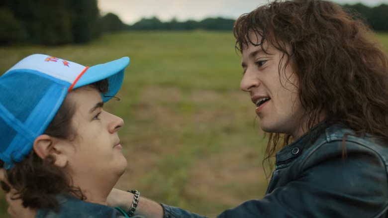 Eddie and Dustin sitting and talking in field