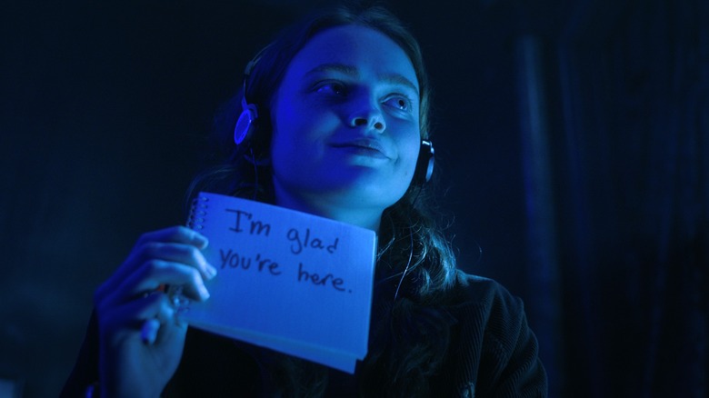 Max holding up written message