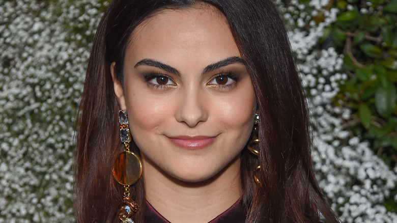 Camila Mendes wearing bold earrings