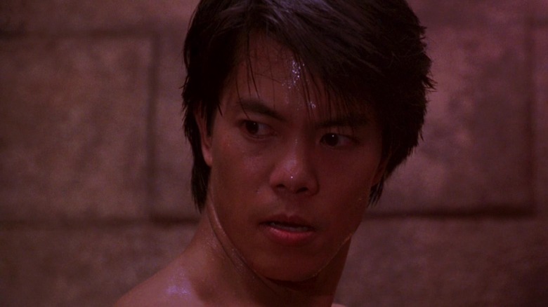 Ryu sweaty and shirtless looking sideways