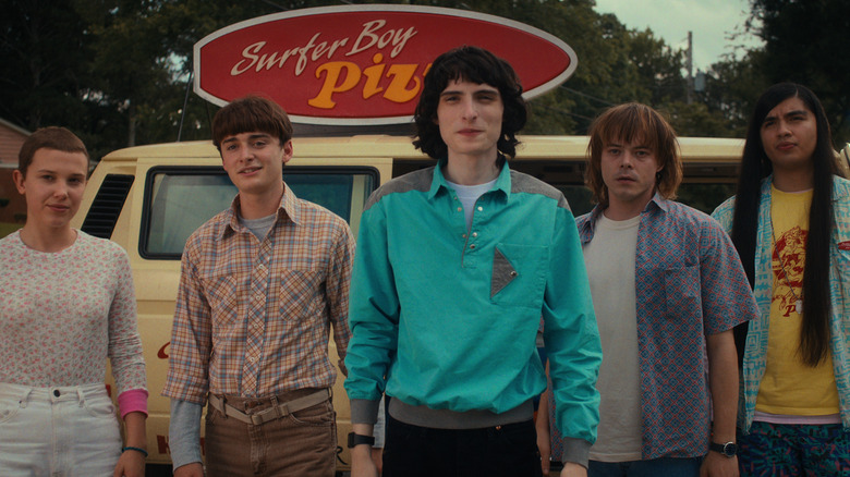 Eleven, Will, Mike, Jonathan, and Argyle standing in front of pizza van