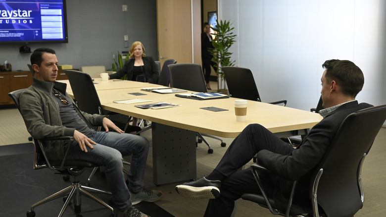 Shiv, Kendall, and Roman sit around a conference table