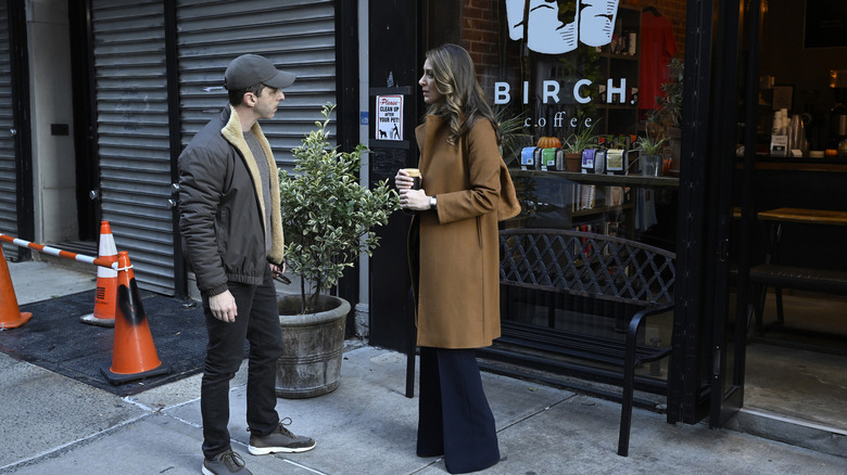 Kendall and Rava stand outside coffee shop