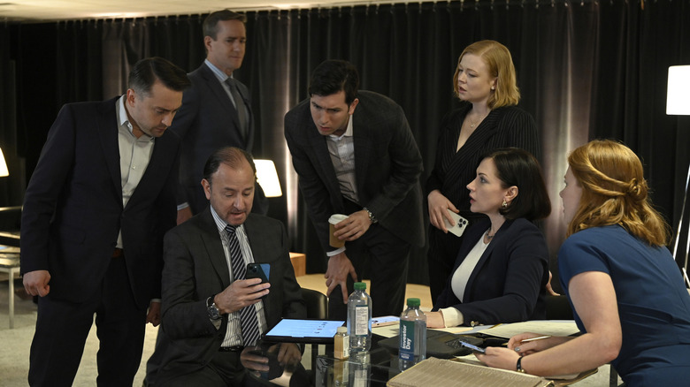 Succession characters staring at phone