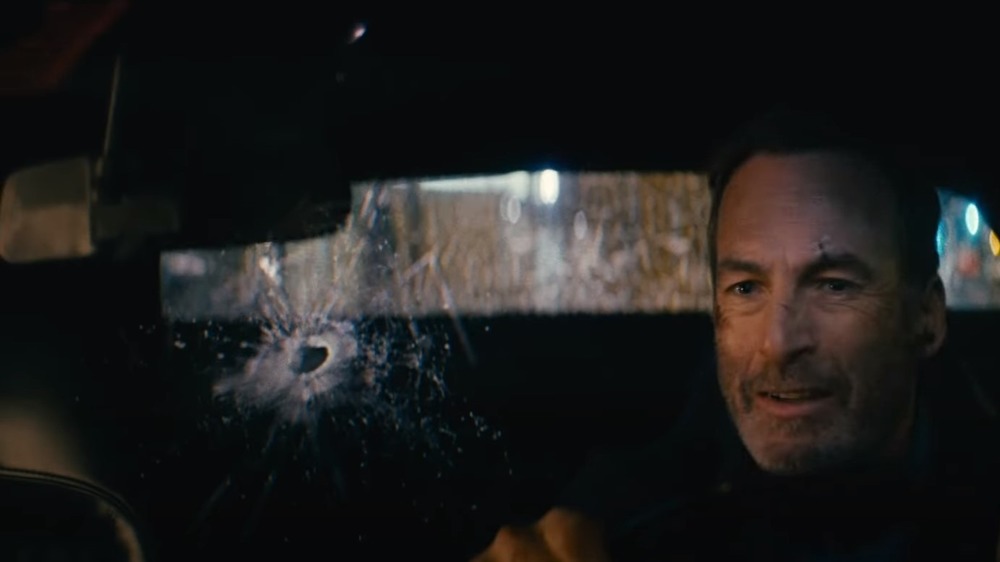 Bob Odenkirk driving with broken windshield