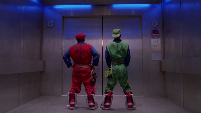 Luigi and Mario high-five in an elevator