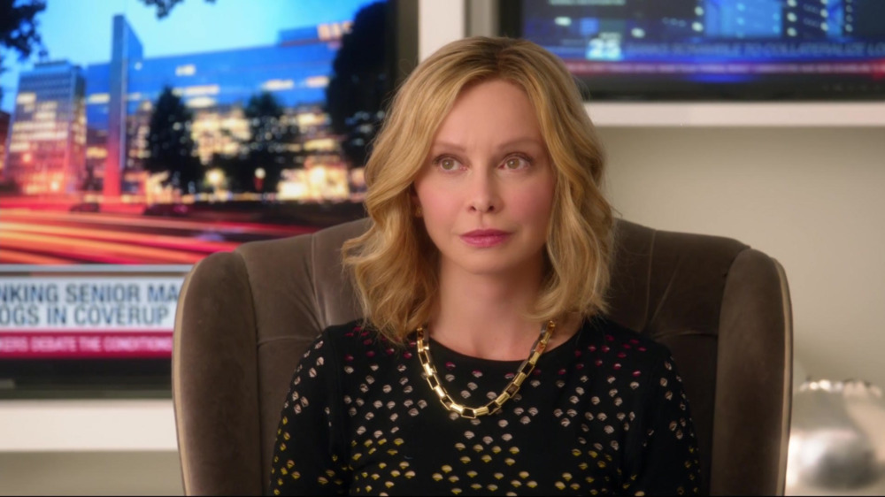 Cat Grant with TVs on the wall