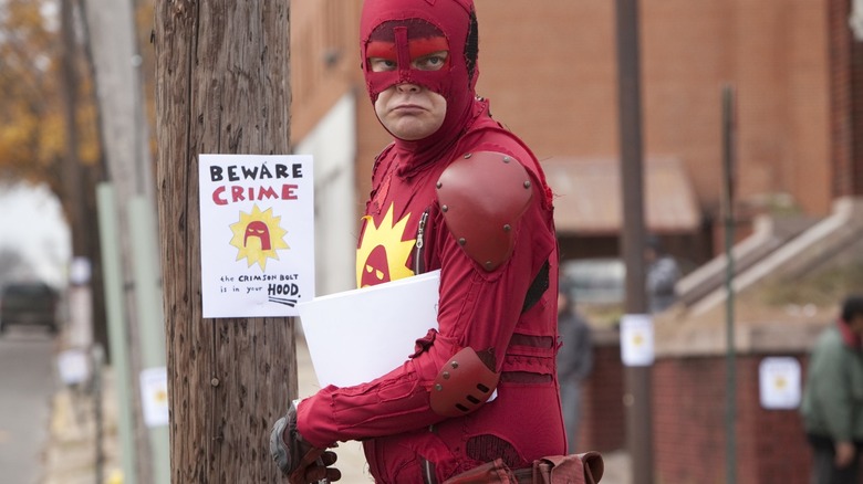 Frank Darbo puts up signs in "Super" (2010)