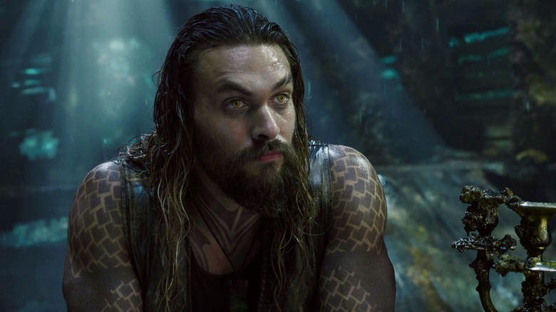 Wet-haired Aquaman listens attentively