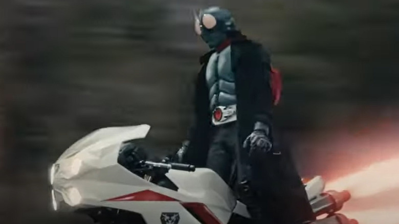 Kamen Rider stands on motorcycle