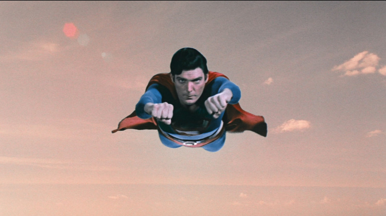 Superman flying against pink sky