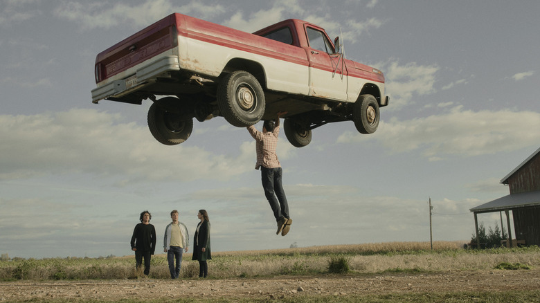 Clark lifts car while family watches