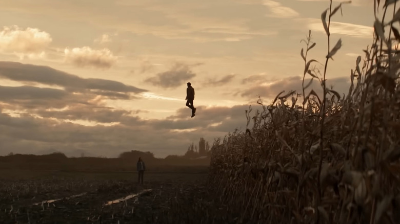 Superman flying in cornfield