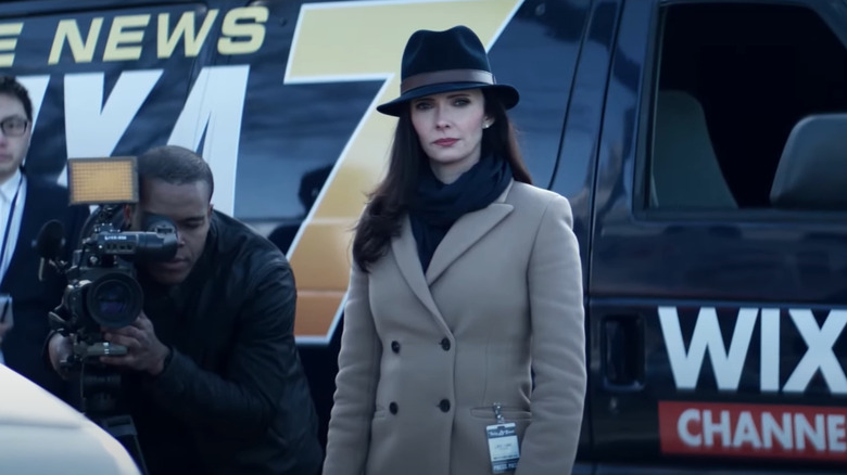 Lois Lane standing outside news van