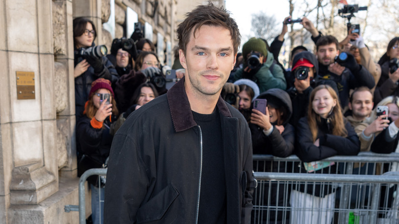 Nicholas Hoult surrounded by fans