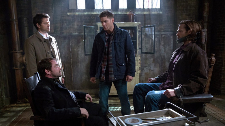 Castiel, Crowley, Dean, Sam talking in dungeon in Supernatural