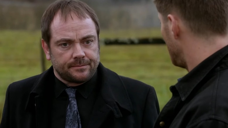 Crowley frowning in a field